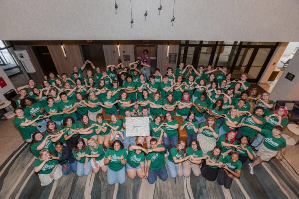 Group photo of 2026 NAfME Collegiate Leadership Advocacy Summit students in green tshirts with Building Bridges theme