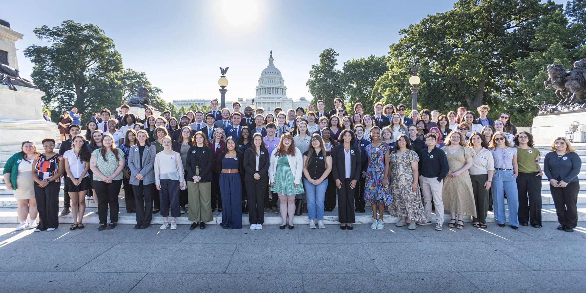 Attendees of the NAfME Collegiate Leadership Advocacy Summit stand in front of the U.S. Capitol building for a group photo - Photo by © Ashlee Wilcox Photography, LLC