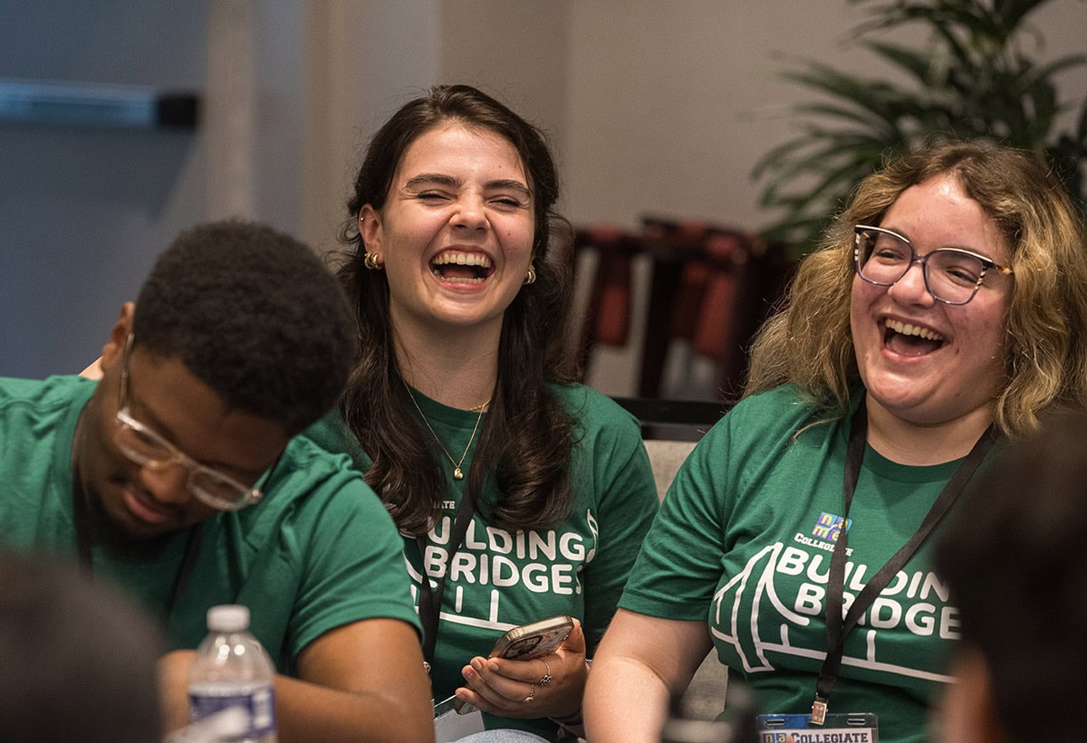 Three collegiate attendees of the 2026 NAfME Collegiate Leadership Advocacy Summit pictured laughing - Photo by © Ashlee Wilcox Photography, LLC