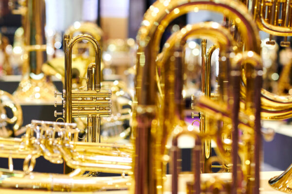 Close-up of golden trumpet at display rack.