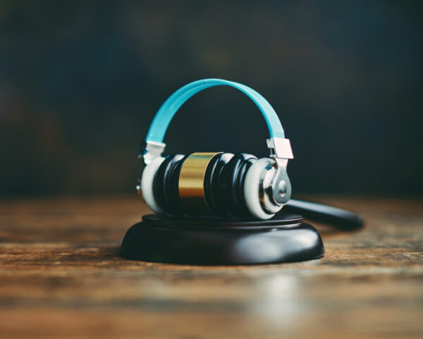 Gavel with headphones. Concept of legal issues and the music industry