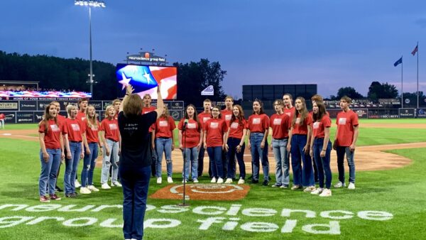 Secondary choir singing at baseball game