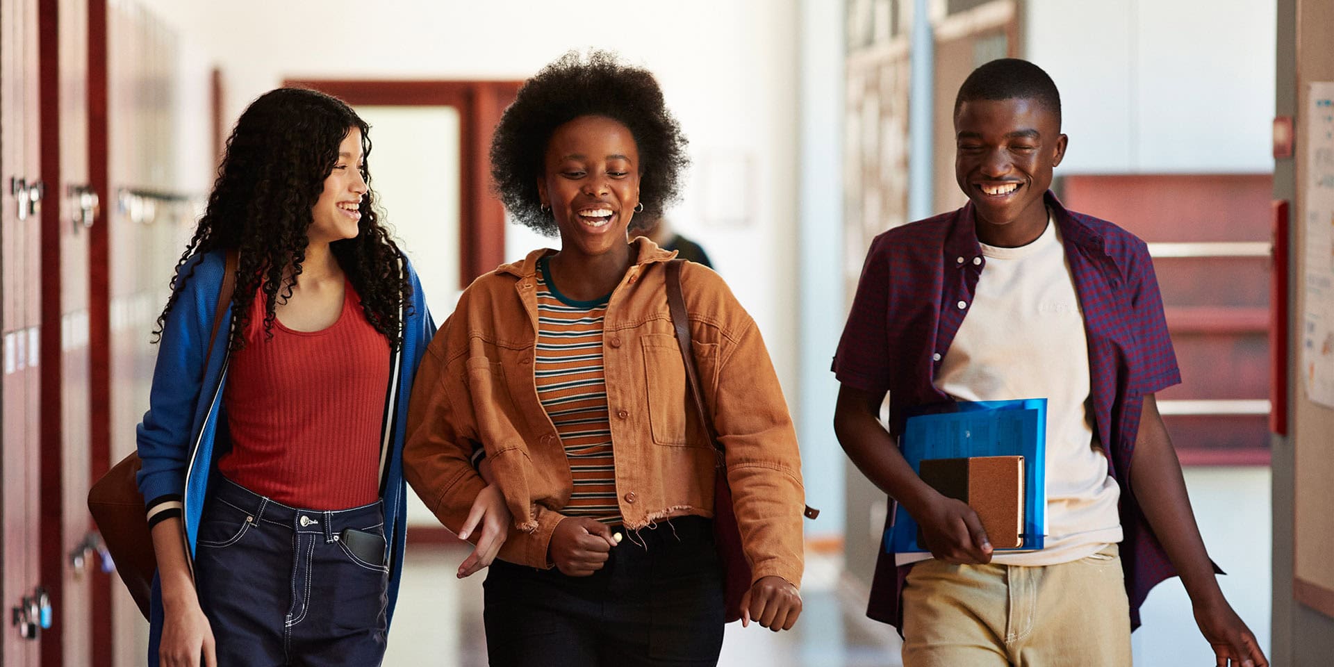 Smiling middle school students in the hallway