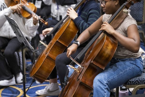 student cellist in rehearsal